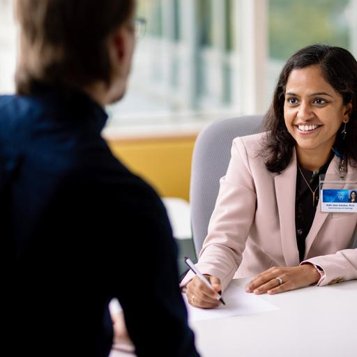 Two Mayo Clinic employees collaborate with each other at Mayo Clinic Alix School of Medicine.