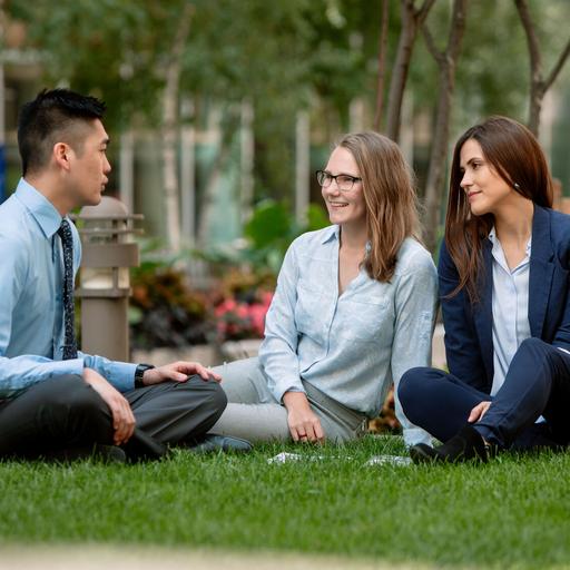 Three medical students talking to each other on the lawn outside of Mayo Clinic Alix School of Medicine in Rochester, Minnesota.