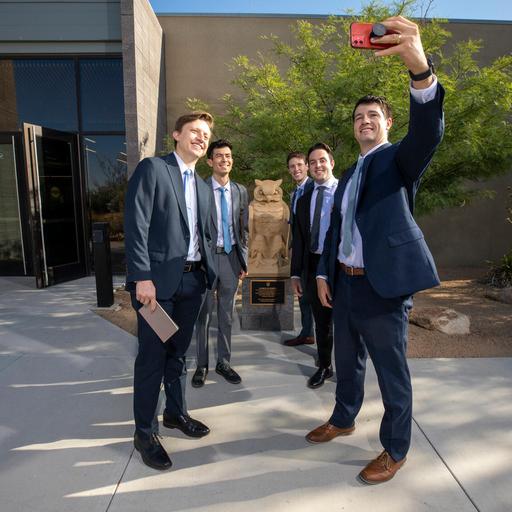 Medical students taking a group selfie outside of Mayo Clinic Alix School of Medicine.