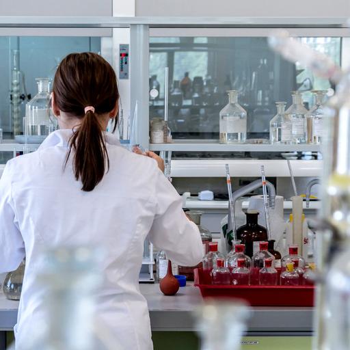Q woman working in a laboratory