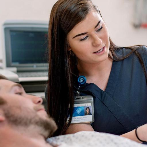 A Cardiac Monitoring and Interpreting Technician shows labwork to a patient at Mayo Clinic