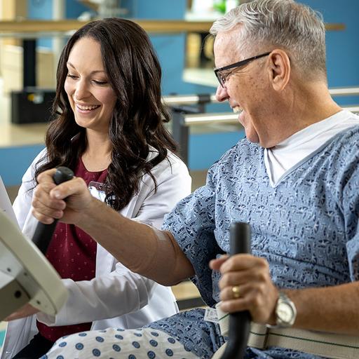 Occupational therapy fellow assists in rehab exercises with a patient at Mayo Clinic