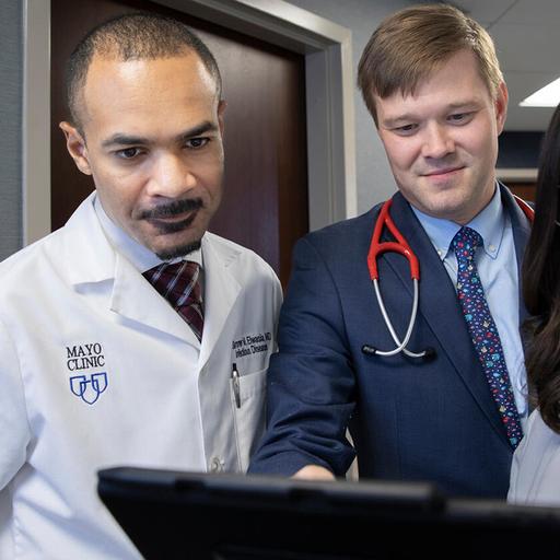 Nurse practitioners and physicians collaborate and review patient forms at Mayo Clinic