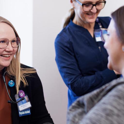 Katie Tahtinen, PA-C, Medical Oncology Physician Assistant, and Holly Sanganoo, RN, OCN, Chemotherpay Nurse, tend to a patient receiving chemotherapy.