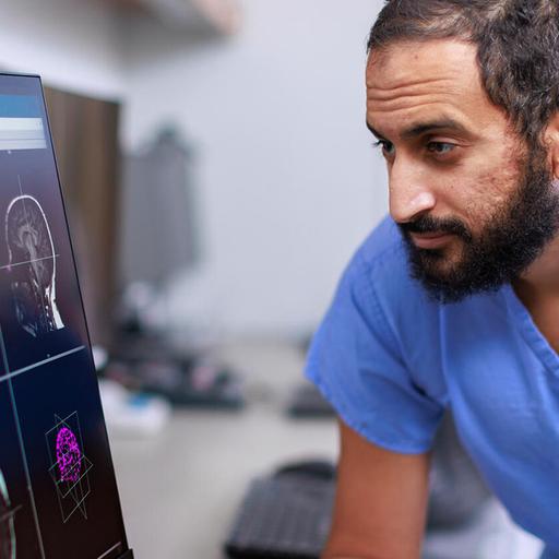 Neurology consultant looks at magnetoencephalography monitor at Mayo Clinic