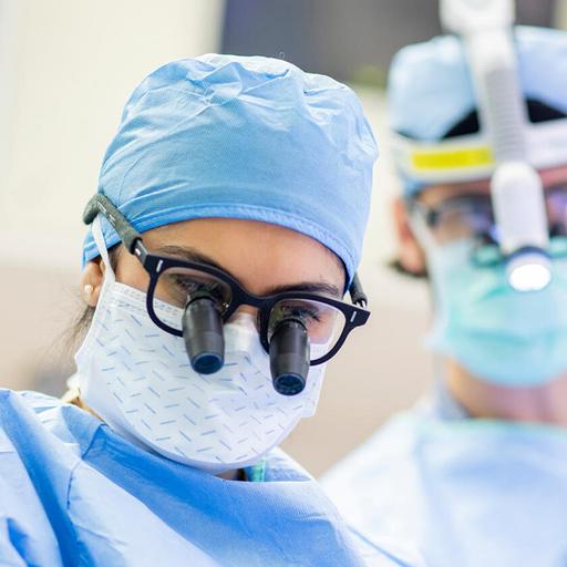 Rushna Ali, M.D. and an assisting doctor, performed surgery in an operating suite.
