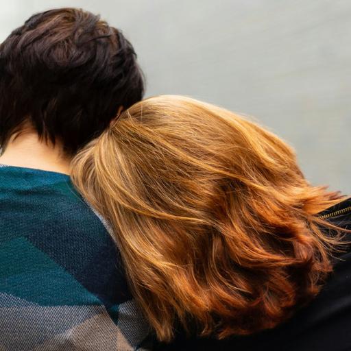 A person leaning their head on another person's shoulder