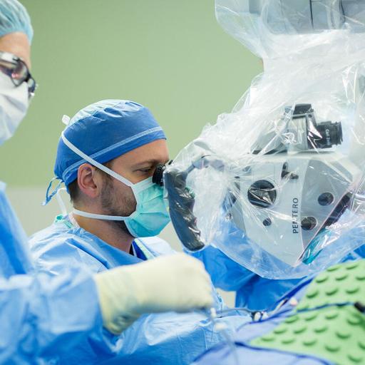 A physician assistant assists in the operating room during a neurosurgery fellowship at Mayo Clinic