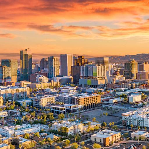 A colorful sunrise is shown over an Aerial view of downtown Phoenix, Arizona.
