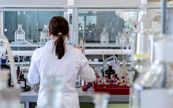 Q woman working in a laboratory