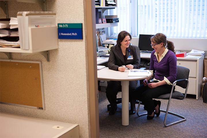 A student working with a graduate school professor.