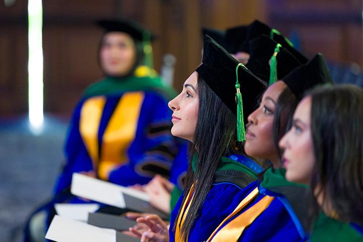 Medical school graduates sit and listen in a row during commencement ceremonies at Mayo Clinic