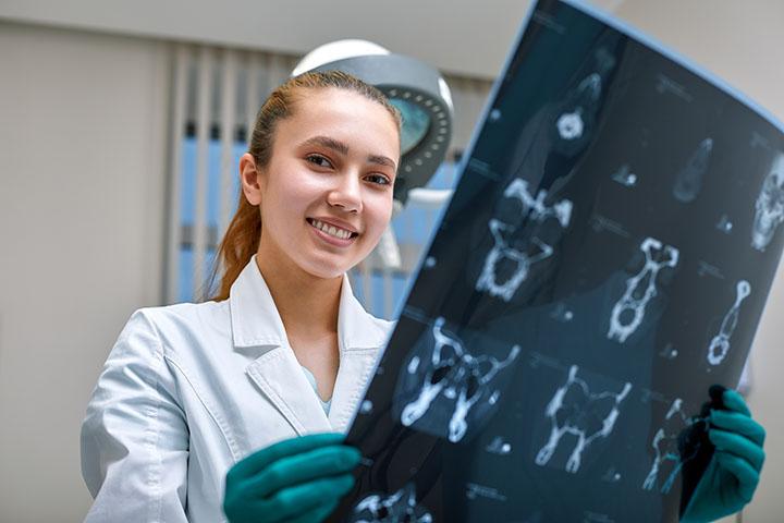 MRI technologist examines MRI scans in a patient room at Mayo Clinic