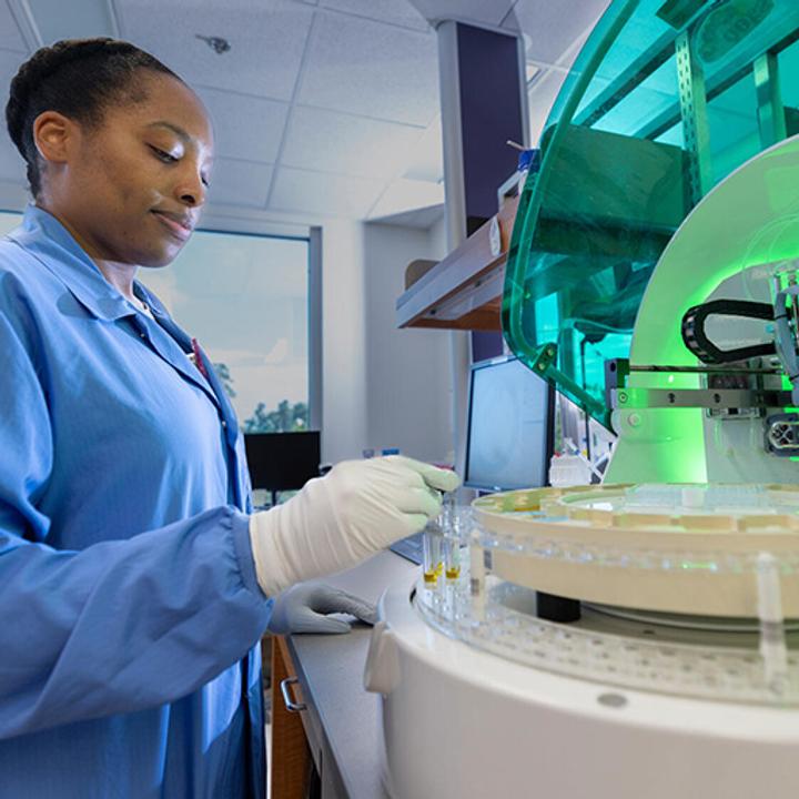 A person from the Anatomic and Clinical Pathology Residency program at Mayo Clinic in Jacksonville, Florida, samples into an automated immunofluorescence processor.
