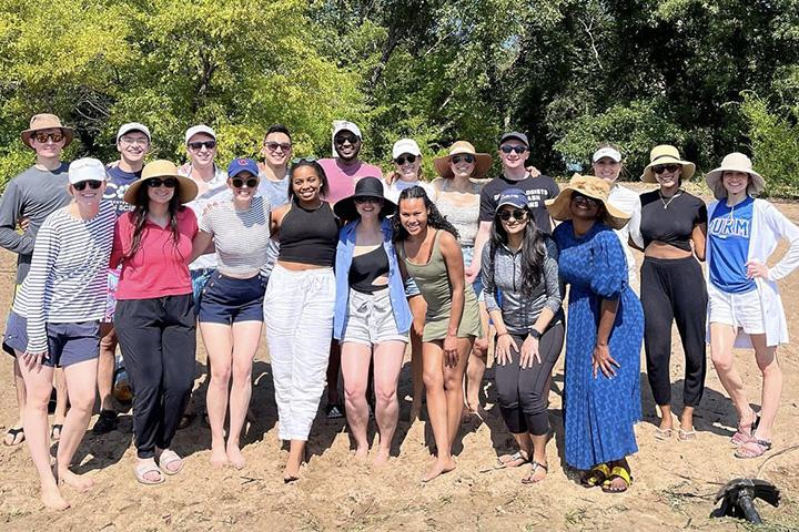 Nineteen people from the Dermatology Residency in Rochester, Minnesota, gathered for a group photo while on a beach outing.