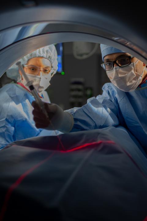 Residents perform cat scan guided imaging