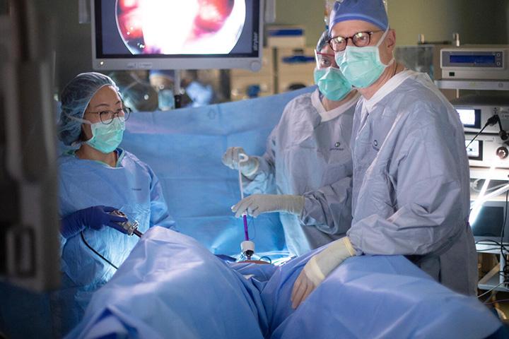 Three fellows in operating suite