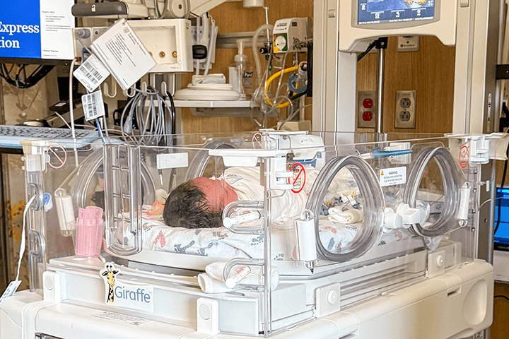 Baby in NICU bed