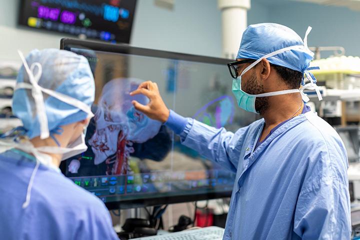 Mayo Clinic neurosurgical resident viewing enhanced cranial images in the operating room