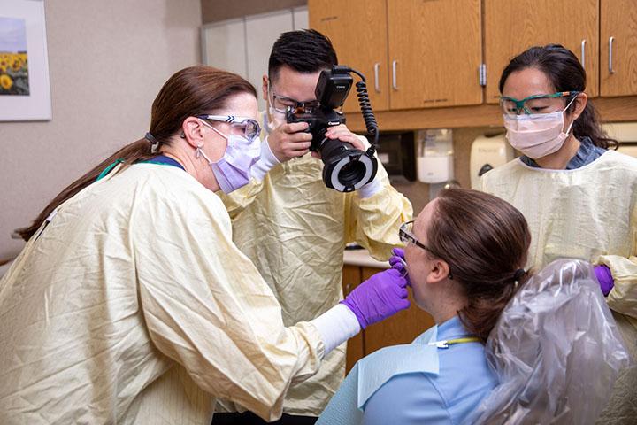 Mayo Clinic residents assist in a dental procedure