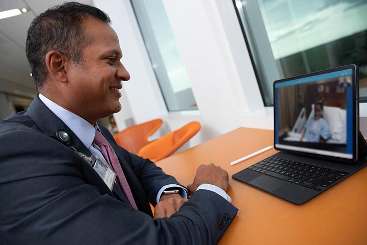Program Director Neal Patel, M.D. speaking with a patient virtually in an office at Mayo Clinic in Jacksonville, Florida.
