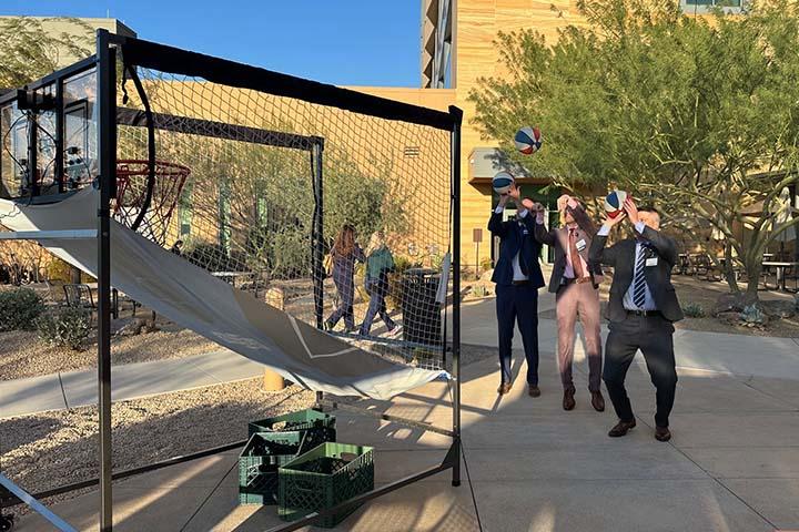 Figure 2 Drs. Sperduto, Kunath, and Toesca shooting hoops outside of the Desert Grove Cafe.