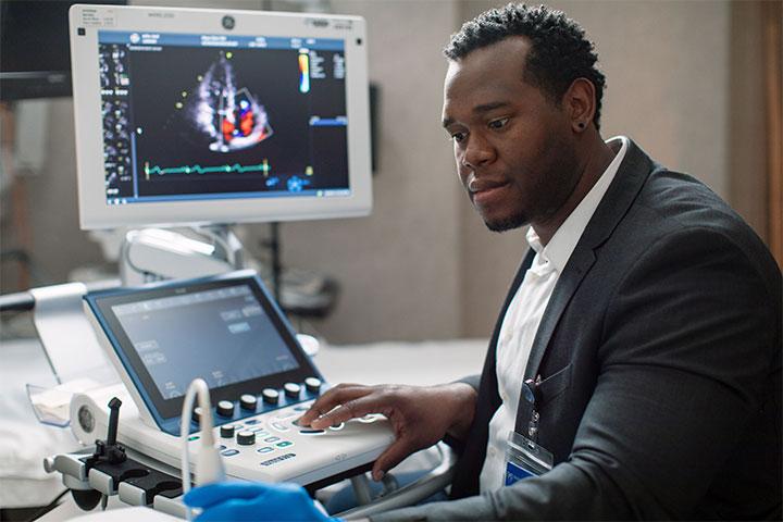 Echocardiography student performing echocardiogram