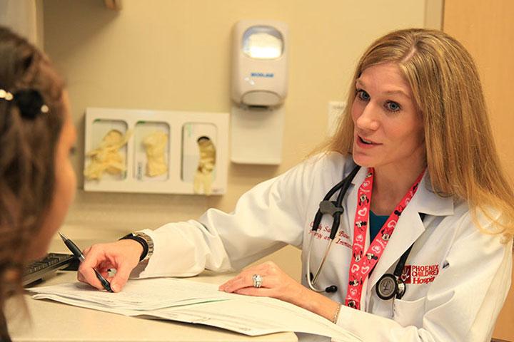 Phoenix Childrens Hospital faculty speaking with a patient.