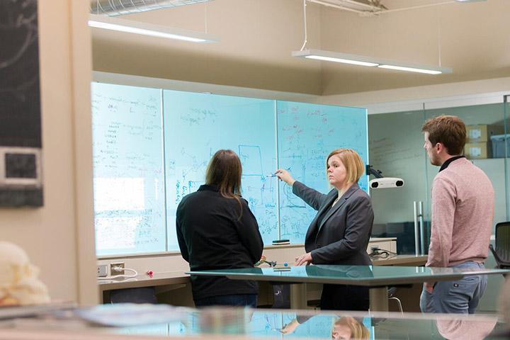 Behavioral Neurology fellows and faculty member speak together in a classroom at Mayo Clinic in Phoenix, Arizona.