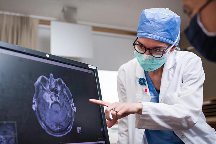 doctor pointing at computer monitor