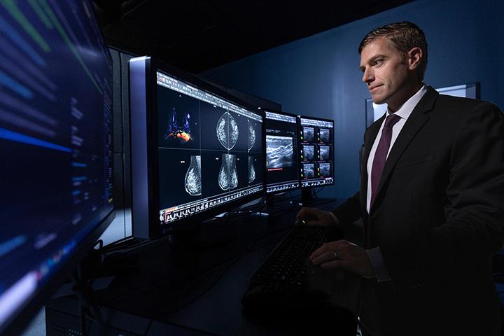 Santo Maimone, MD, Diagnostic Radiology Consultant, reviews a scanned image on a screen.