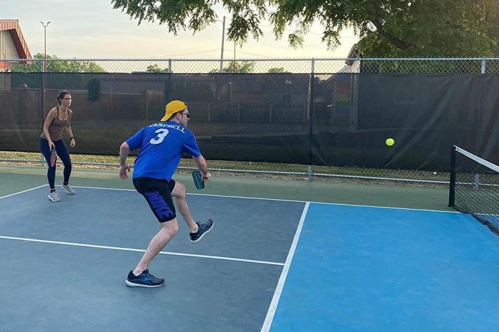 Two residents play pickelball.