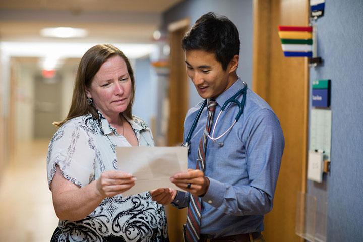Family Medicine resident collaborating with a physician in the hallway