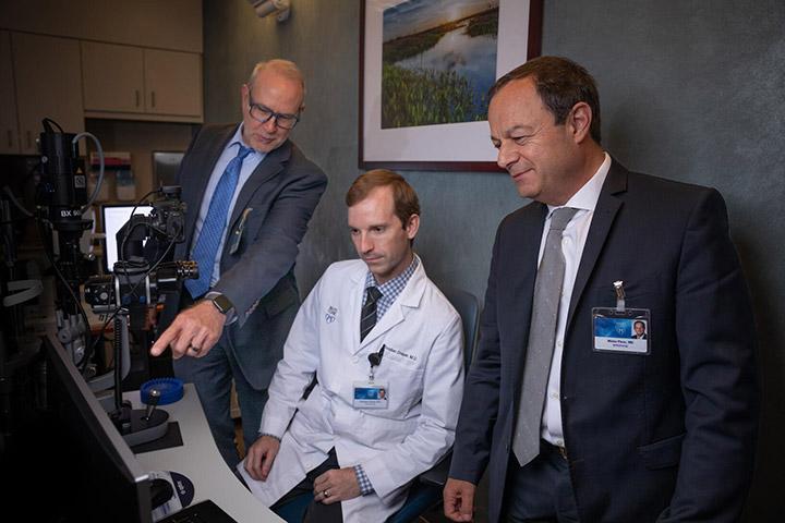 Neuro-ophthalmology fellows and faculty look at scans on a computer at Mayo Clinic in Jacksonville, Florida.