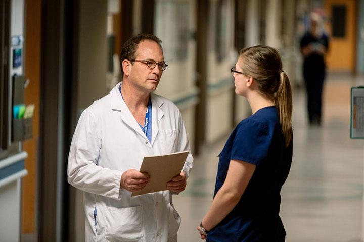 Faculty and residents collaborating in the hallway