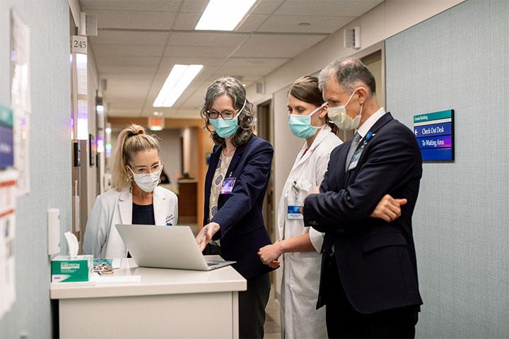 Dr. Bradley consults with fellows in the hall at Mayo Clinic in Rochester, Minnesota.