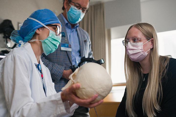 Ophthalmology faculty and residents with a skull model.