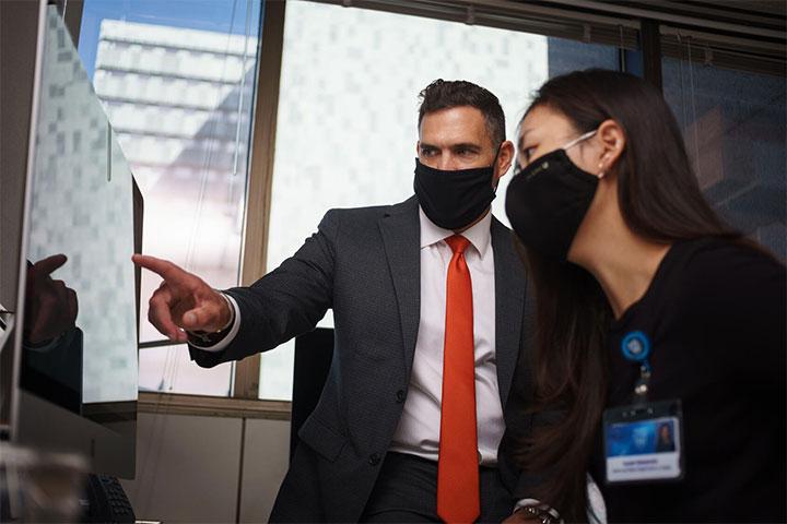 Nathan LeBrasseur, Ph.D. of Physical Medicine and Rehabilitation working on a computer with a resident at Mayo Clinic in Rochester, Minnesota.