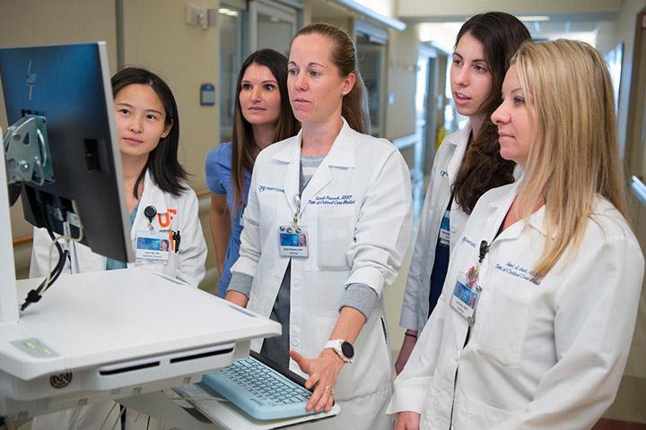 Pulmonary and Critical Care Medicine fellows and faculty talking in the hallway at Mayo Clinic in Jacksonville, Florida.