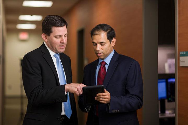 Dr. Ashman, program director, speaking with a resident at Mayo Clinic in Phoenix, Arizona.
