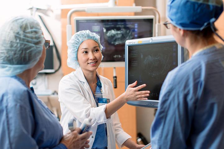 Mayo Clinic Renal Transplant Fellowship program doctor and staff having a discussion in medical room.