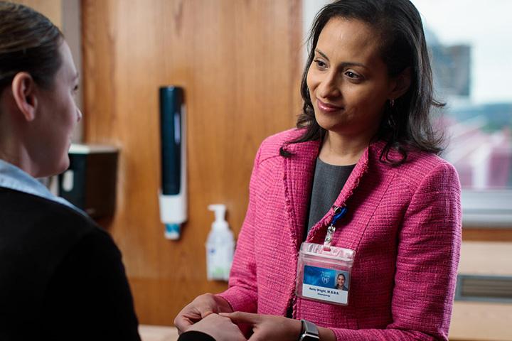 Rheumatology doctor working with a patient.