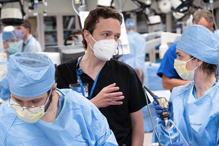 Three fellows from rhinology and skull base sursgery fellowship performing procedure