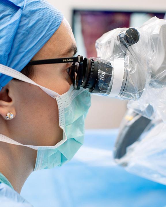 Trauma and Genitourinary Reconstruction Fellowship doctor performing surgery in an operating room.