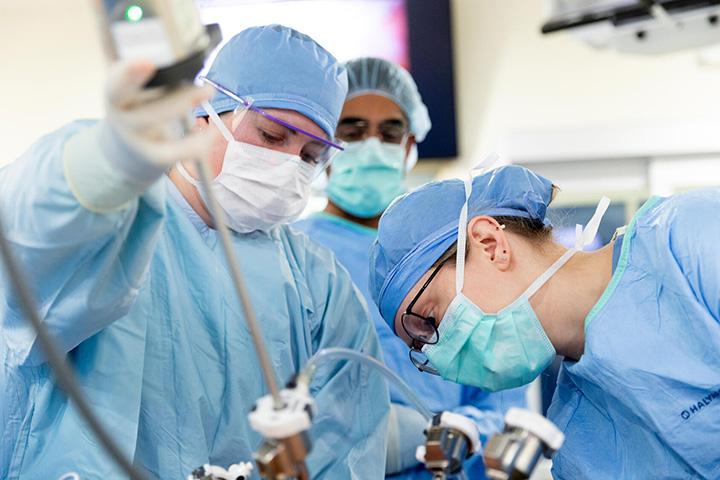 Abhinav Khanna, MD, Urology surgeon, leads the surgical team and urology residents in setting up instrumentation for a robotic surgical procedure.