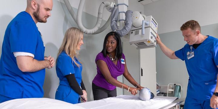 Mayo Clinic students and faculty with a x-ray machine model