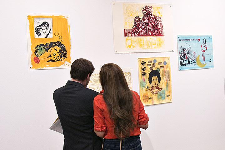 Man and woman looking at paintings at Rochester Art Center