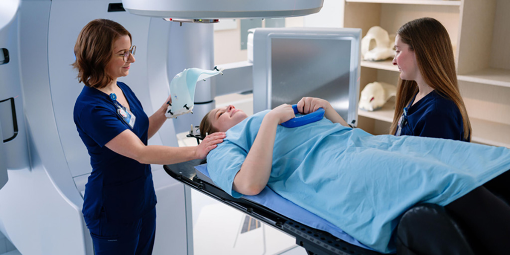 Radiation Therapy technicians assist a patient during a procedure