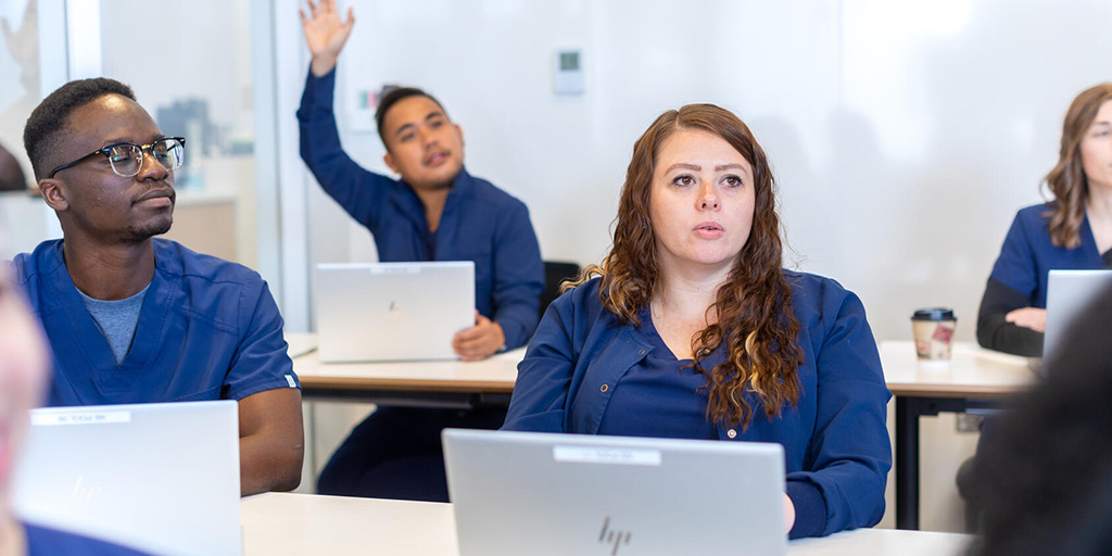 Medical students listen and engage in a classroom setting